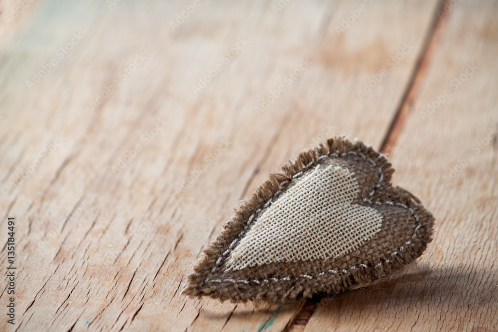 Fototapeta premium Heart made of cloth on wood desk