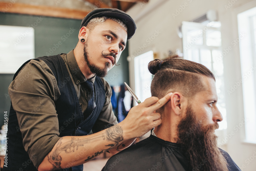 Fototapeta premium Barber checking symmetry of haircut