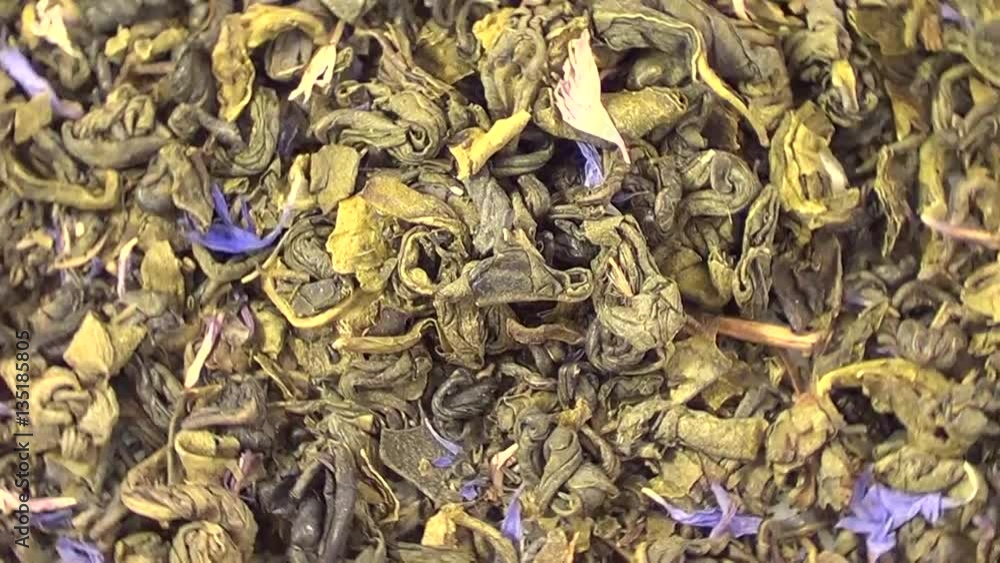 Green tea with bergamot rotating, close up overhead view, healthy eco organic drink Green tea with bergamot rotating, close up overhead view, healthy eco organic drink