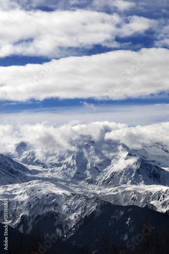 View on snow mountains and sunlight cloudy sky at winter day © BSANI
