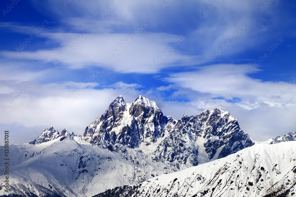 Snow mountains and blue sky with clouds in winter