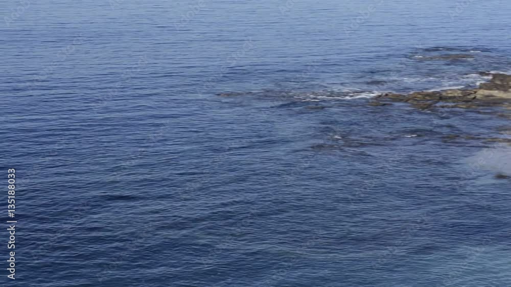 Beautiful pan of a secluded cover across a blue ocean to famous Seal Rocks in Laguna Beach, California. Beautiful pan of a secluded cover across a blue ocean to famous Seal Rocks in Laguna Beach, California.