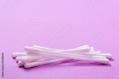 closeup clean ear sticks on violet background slide