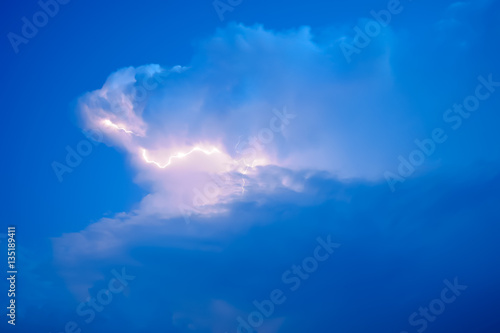 Lightnings in storm clouds. Peals of a thunder and the sparkling lightnings in clouds