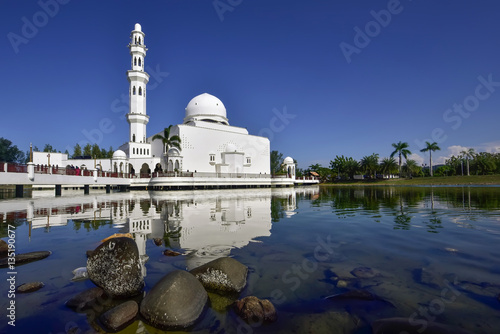 The Tengku Tengah Zaharah Mosque or the Floating Mosque during day light and it is the first floating mosque in Malaysia. It is situated in Kuala Ibai Lagoon, Terengganu, Malaysia. photo