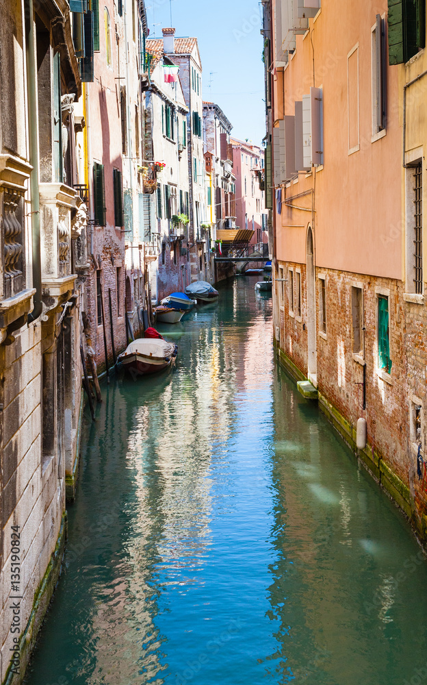 narrow canal in center of Venice city