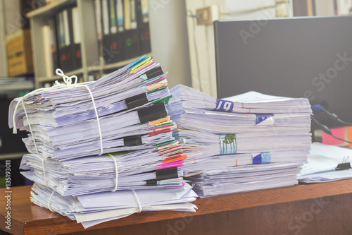 Business papers pile reports stack.