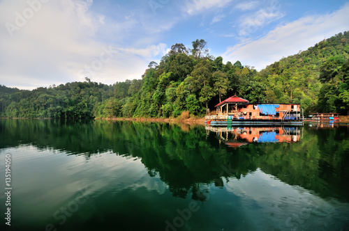 Fishing boat (Houseboat) at tropical rain forest at Kenyir Lake in Terengganu, Malaysia, It is the largest man-made lake in South East Asia.