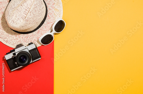 Woman's accessories flat lay on colorful background. Top view. Red and yellow pastel colors with copy space around products. Horizontal image or photograph.