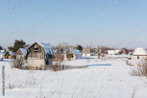 Houses in snow. The country house costs in snow.