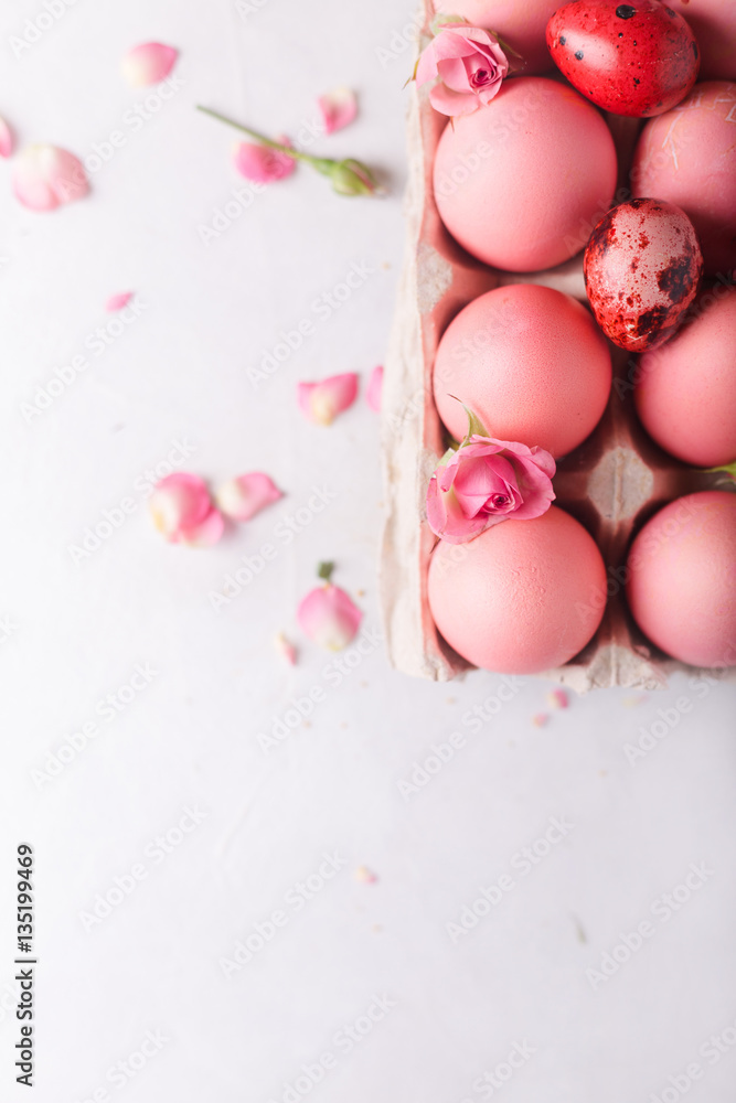 Pink Easter eggs on light background. Copyspace. Still life photo of lots of pink easter eggs.Background with easter eggs. Pink eggs and roses. Easter photo concept