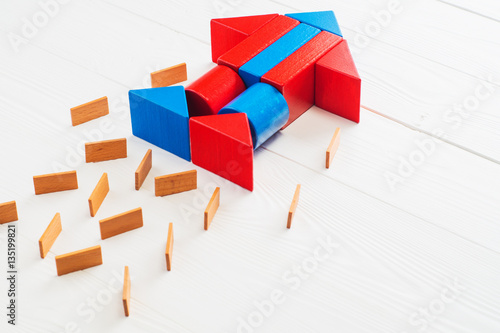 Abstract rocket from colored wooden blocks on a white wooden background with copy space.  Business concept  startup  achievement  success. Wooden puzzle in rocket shape  discovery concept