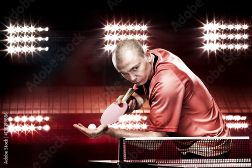 Portrait of sports man, male, athlete playing table tennis isolated on black background