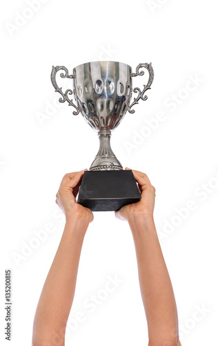 Woman two hand holding a champion silver trophy on white backgro