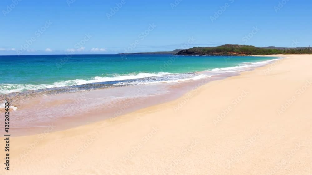 A beautiful white sand beach with clear blue water on a remote beach in Molokai Hawaii.. A beautiful white sand beach with clear blue water on a remote beach in Molokai Hawaii..