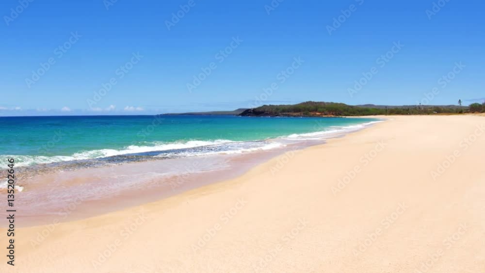 A beautiful white sand beach with clear blue water on a remote beach in Molokai Hawaii.. A beautiful white sand beach with clear blue water on a remote beach in Molokai Hawaii..