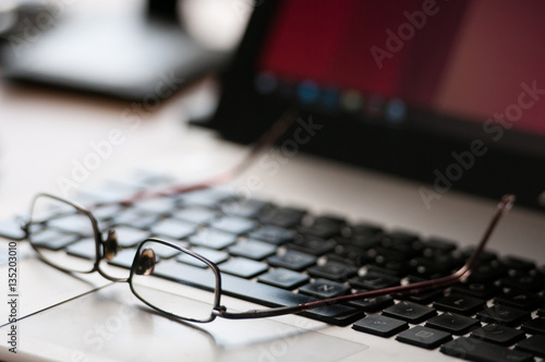 Glasses on the laptop. Business concept.