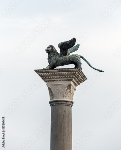 Crowning the winged lion ancient column in the square of San Marco - Venice, Italy photo