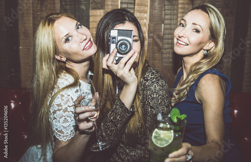 Photography Party girls in a restaurant celebrating with drinks and champagne