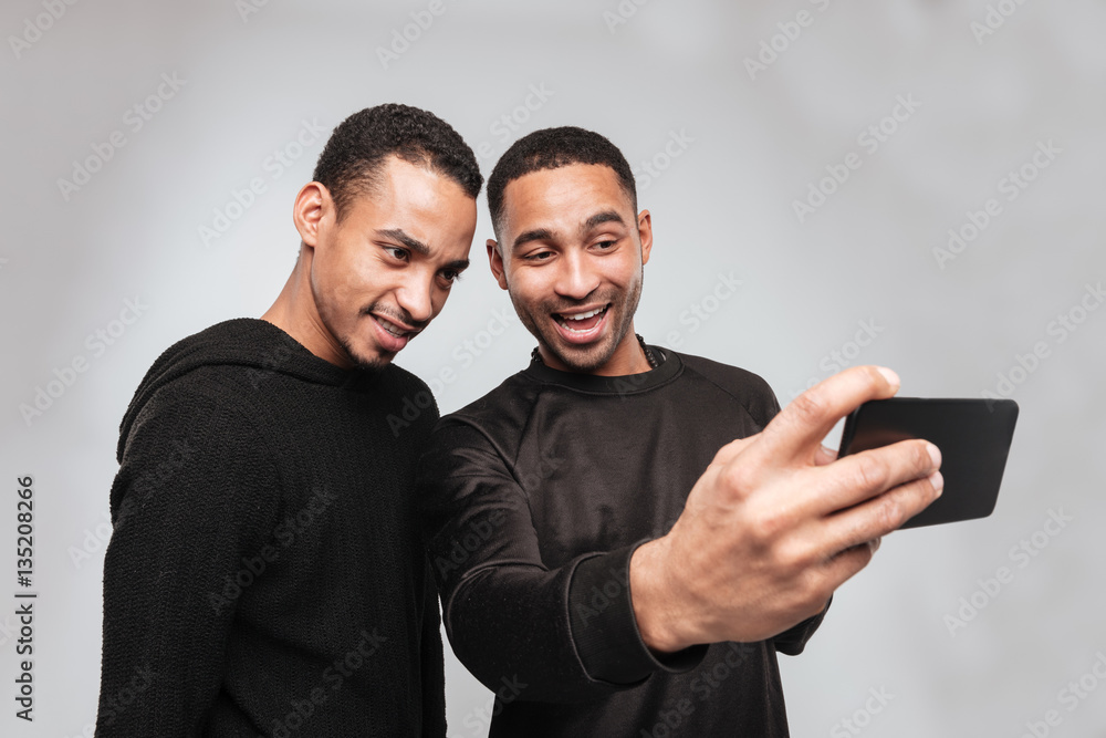 Two young cheerful african men make a selfie.