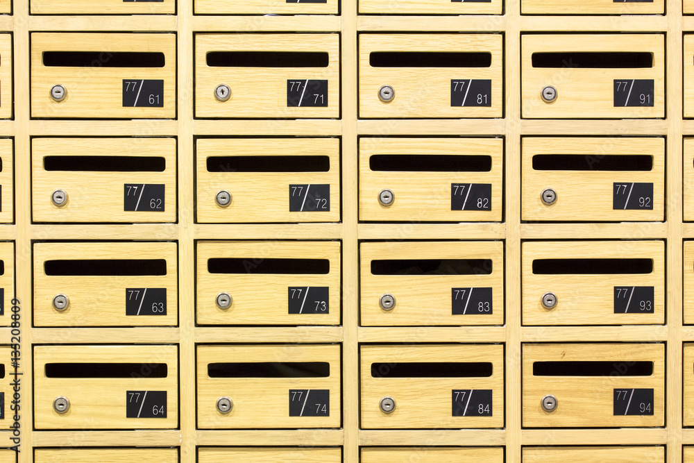 Front view of yellow wooden postboxes apartment. Locker wooden mail boxes postal Front view of yellow wooden postboxes apartment. Locker wooden mail boxes postal