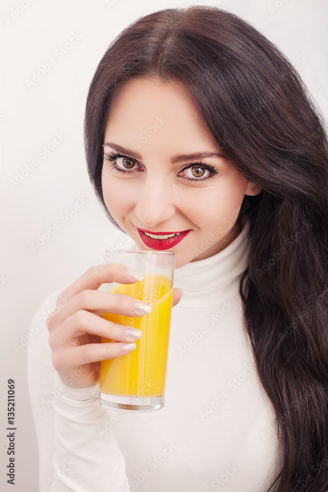 Diet. Healthy Lifestyle. A young girl drinking fresh orange juice. White background Diet. Healthy Lifestyle. A young girl drinking fresh orange juice. White background