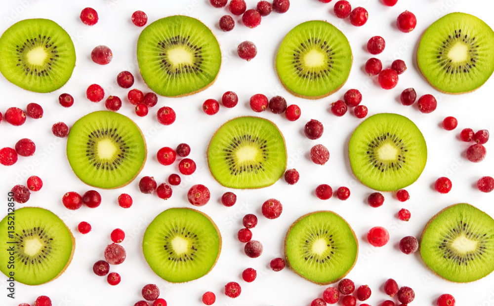 Fototapeta premium Fresh fruit kiwi and cranberries closeup of a flat background