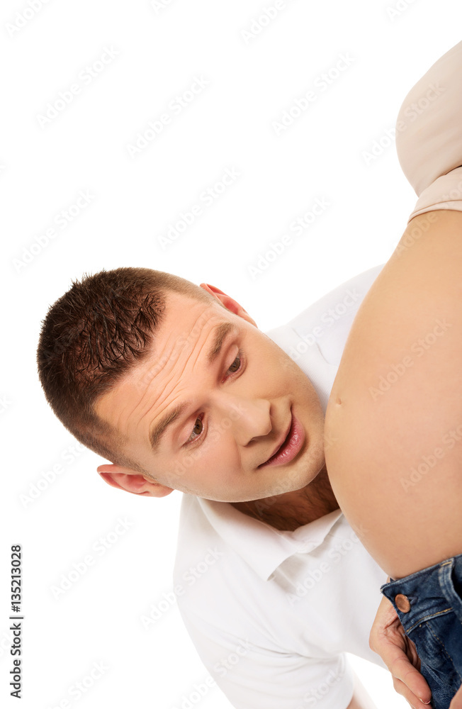 Father talking to mother's pregnant tummy Father talking to mother's pregnant tummy
