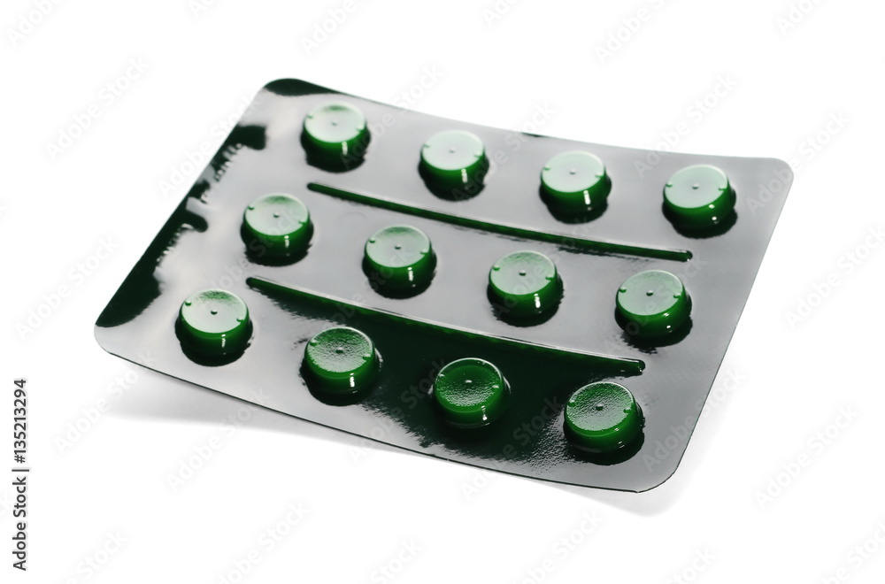 Tablets in green strip isolated on white background Tablets in green strip isolated on white background
