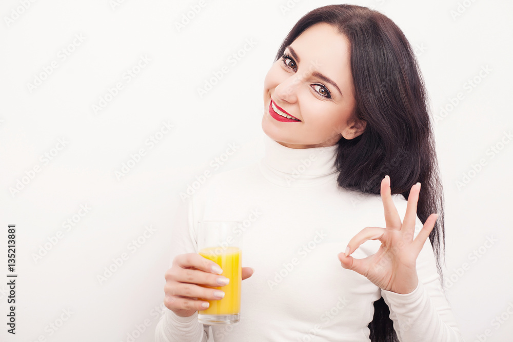 Diet. A beautiful young girl who follows the figure, drinking orange juice. The concept of healthy eating. White background. Diet. A beautiful young girl who follows the figure, drinking orange juice. The concept of healthy eating. White background.