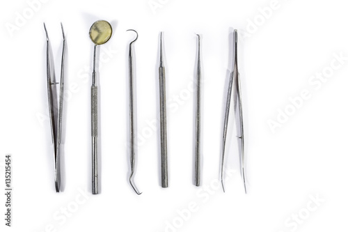 Dental Instruments arranged on white table.