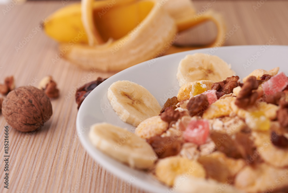 flakes with dried fruit, granola on the plate flakes with dried fruit, granola on the plate