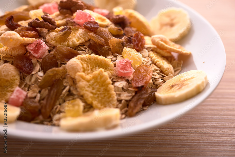 flakes with dried fruit, granola on the plate flakes with dried fruit, granola on the plate