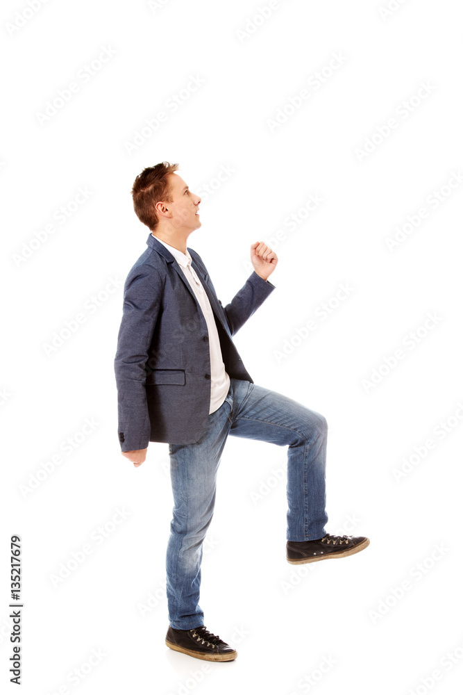 Side view of a businessman climbs the stairs Side view of a businessman climbs the stairs