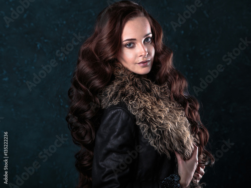 Young brunette woman with perfect natural makeup and hair style wearing furs. fashion beauty portrait