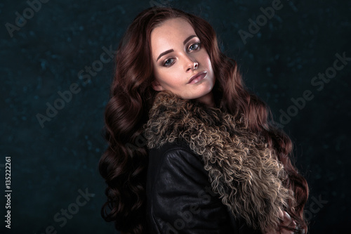 Young brunette woman with perfect natural makeup and hair style wearing furs. fashion beauty portrait