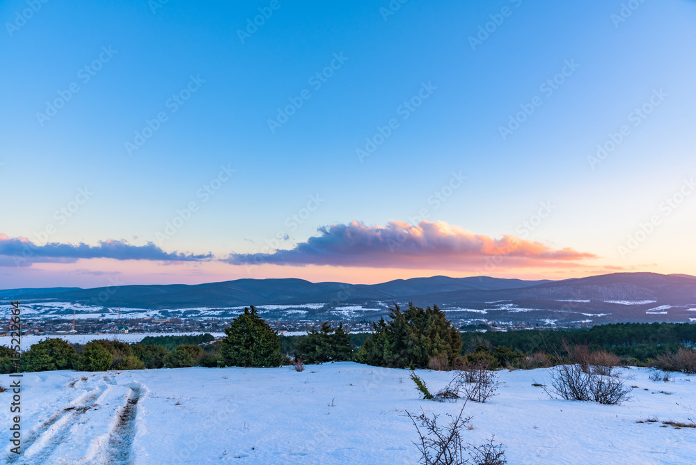 Beautiful winter sunset and the road at the corner. Russia, Stary Krym.