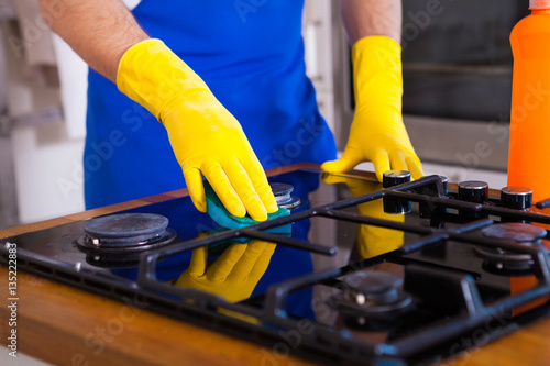 Young Men in rubber protective cleaning and polish cooker. set cleaning concept