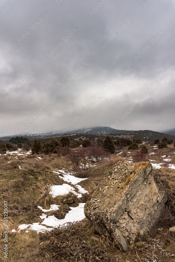 Dramatic winter landscape with foggy mountain and a big stone. Russia, Stary Krym.