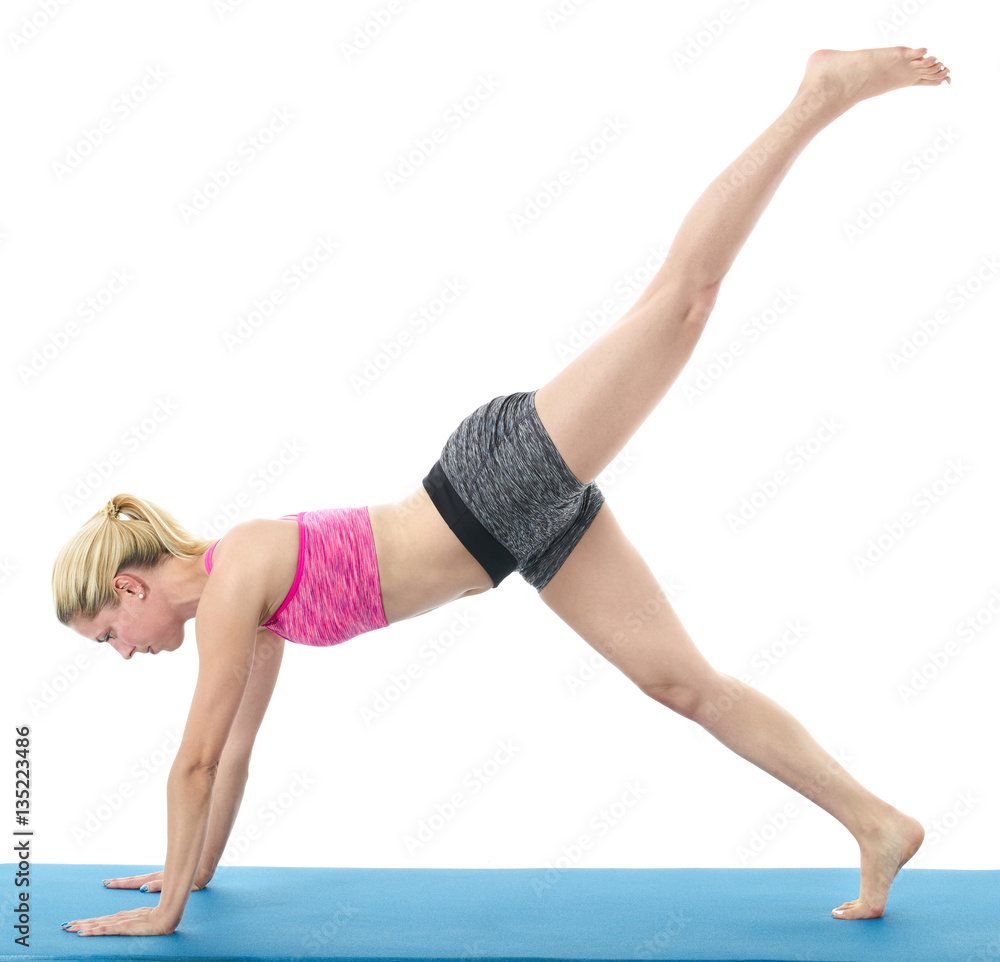 Young woman doing full body yoga exercise on blue mat Young woman doing full body yoga exercise on blue mat