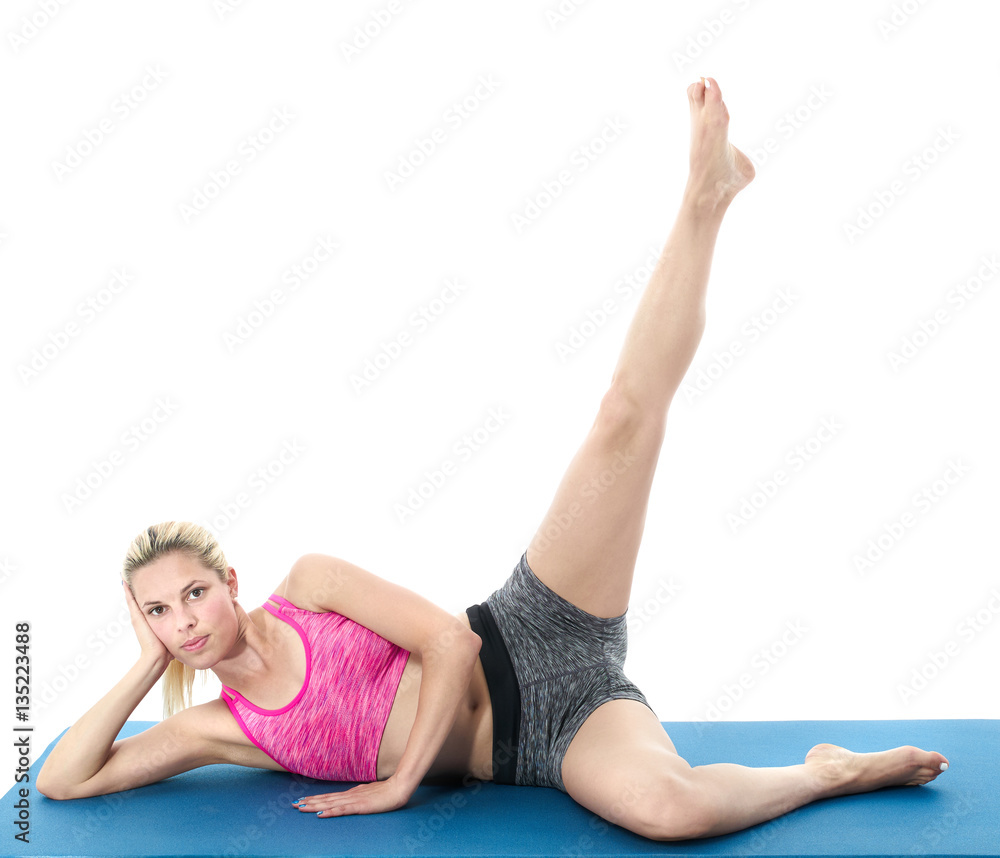 Young woman doing full body yoga exercise on blue mat Young woman doing full body yoga exercise on blue mat