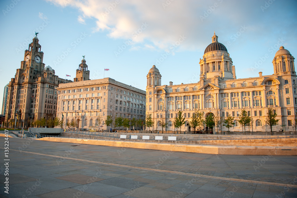Liverpool city centre - Three Graces, buildings on Liverpool's waterfront at dusk, UK. Liverpool, in North West England, is a major city and metropolitan borough with population of 478,580 in 2015.