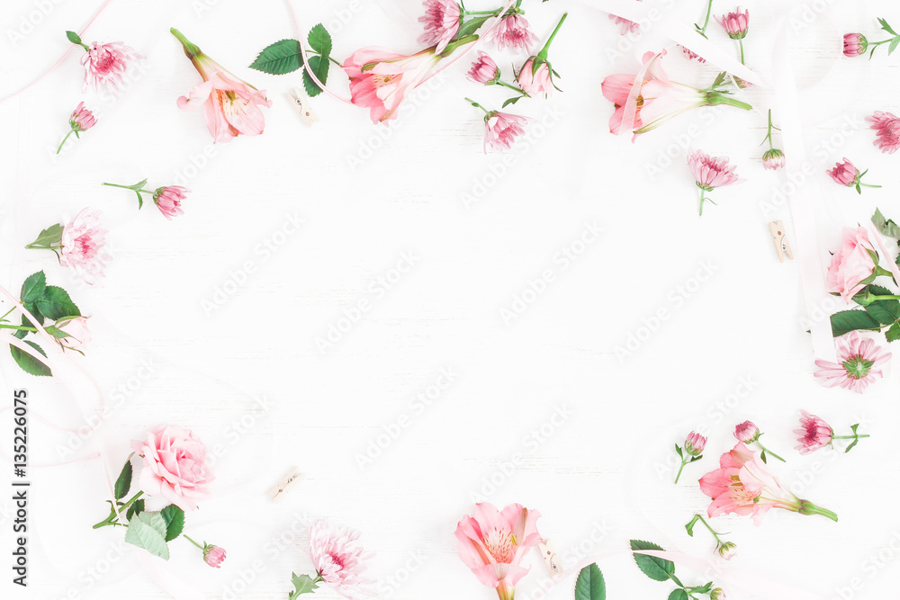 Flowers composition. Frame made of pink flowers and leaves. Top view, flat lay Flowers composition. Frame made of pink flowers and leaves. Top view, flat lay