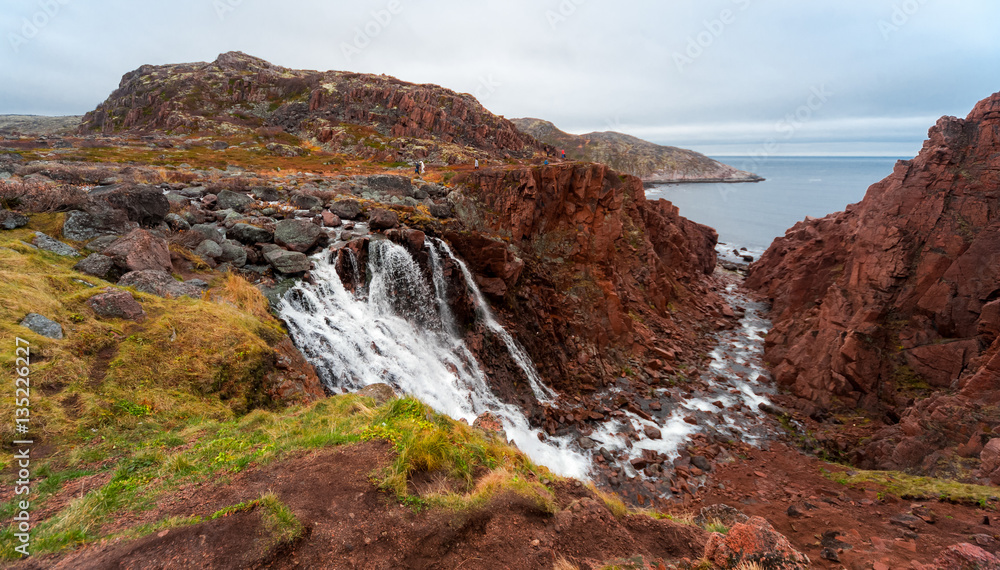 Fototapeta premium Paints of autumn and waterfall. The coast of the Barents Sea. Kola Peninsula, Murmansk region