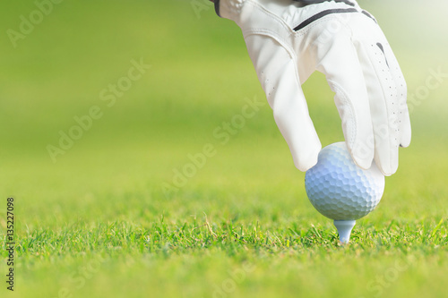 Golf ball on tee in golf course