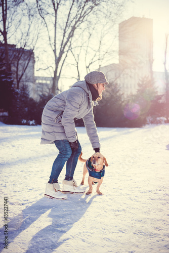 Woman Petting Dog In Snow