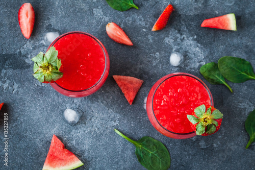 Summer cocktail with watermelon and strawberry on stone background. Top view, flat lay