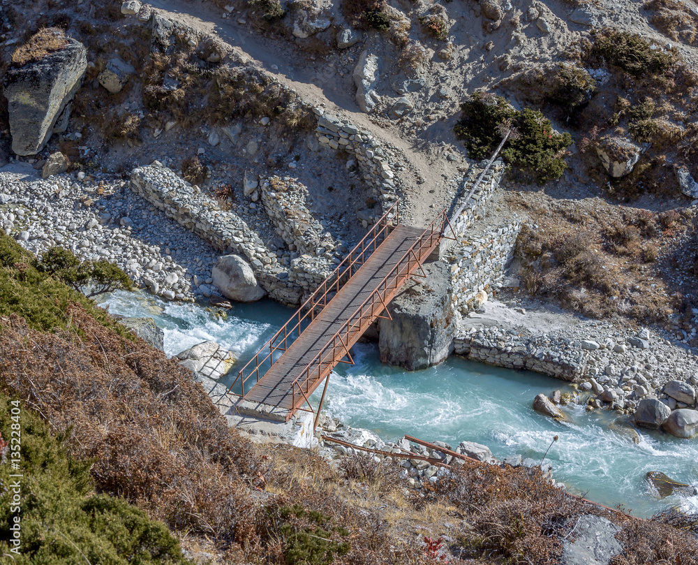 The metal bridge on the trail to Everest near Periche village - Nepal, Himalayas The metal bridge on the trail to Everest near Periche village - Nepal, Himalayas
