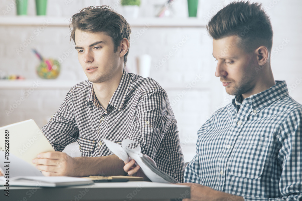 Portrait of handsome men doing paperwork Portrait of handsome men doing paperwork