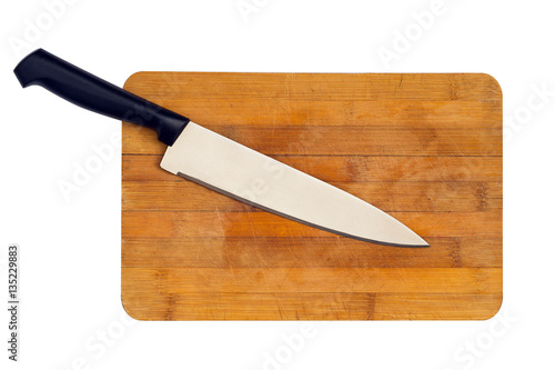 Kitchen knife on a wooden cutting board. Isolated on white background.